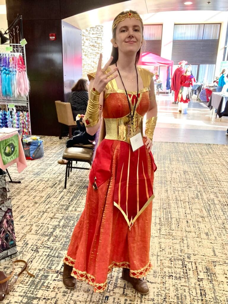 Photo of Riverly Twardy at Mars Con 2026, wearing her Kyndara cosplay and smiling at the camera.